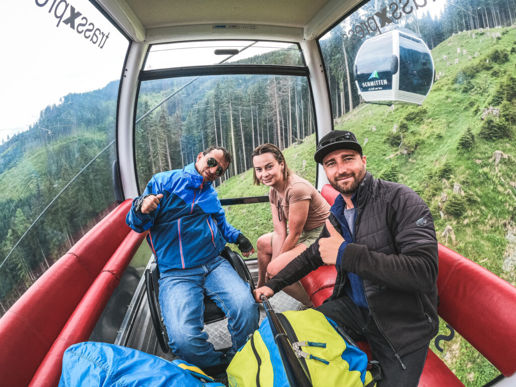 A wheelchair user in the gondola with pilot Sepp