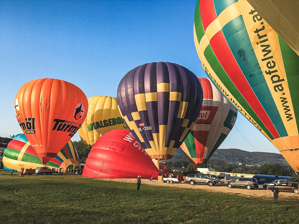 many colorful balloons launch together