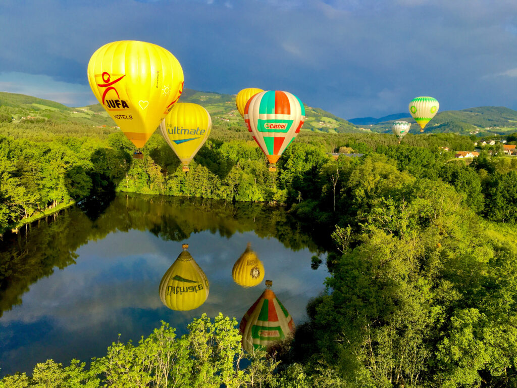 Balloons over lake in summer